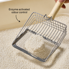 Snow cassava cat litter on a scoop, with enzyme activated odour control