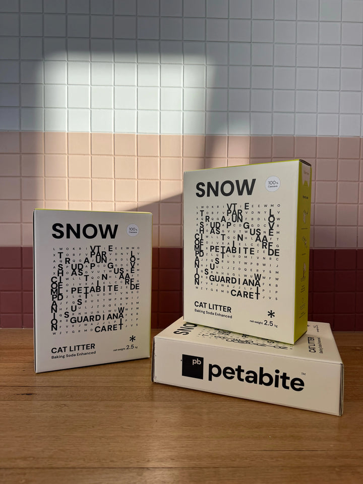Three Snow boxes against a tiled wall