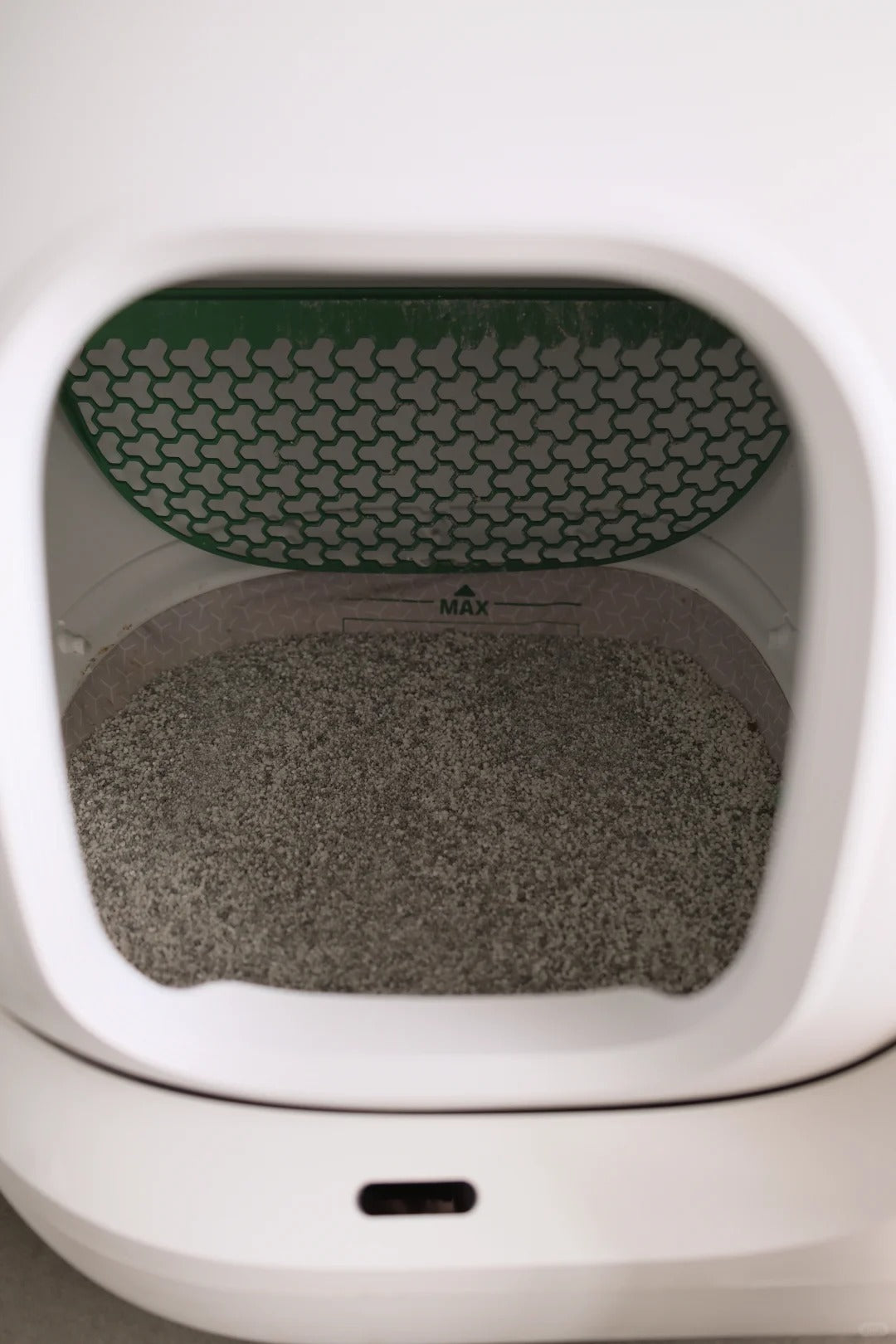 Terra litter inside a white automatic litter box
