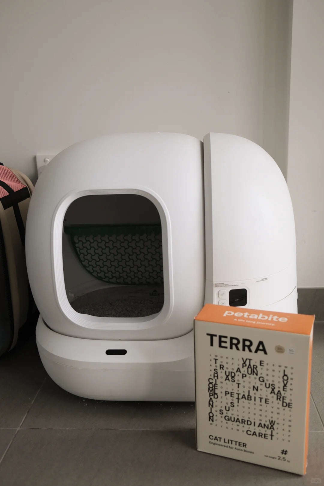 Terra box beside a white automatic litter box